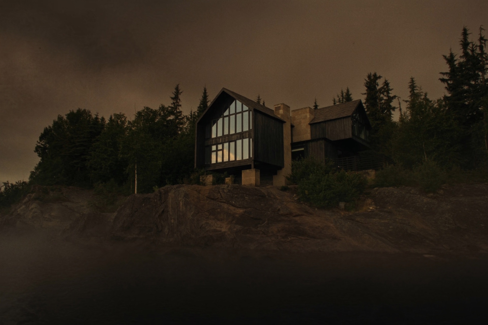 Gunflint — a timber and granite house above Lake Superior near Grand Marais, dusk light on the water beyond